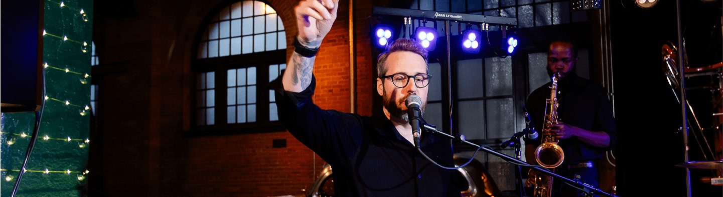 close-up of gentleman singing on stage