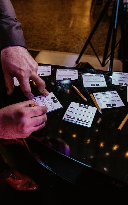close-up of gentleman writing song on paper