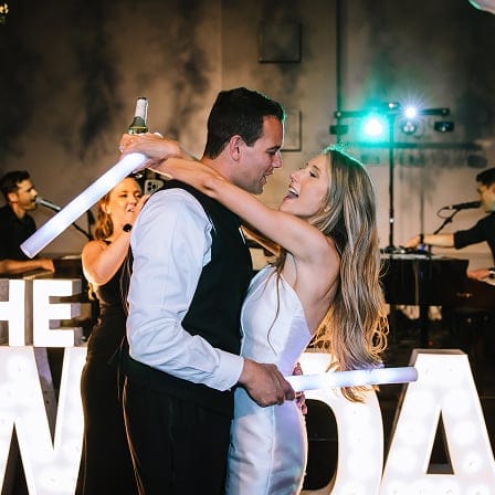 bride and groom dancing and singing in the middle of dance floor