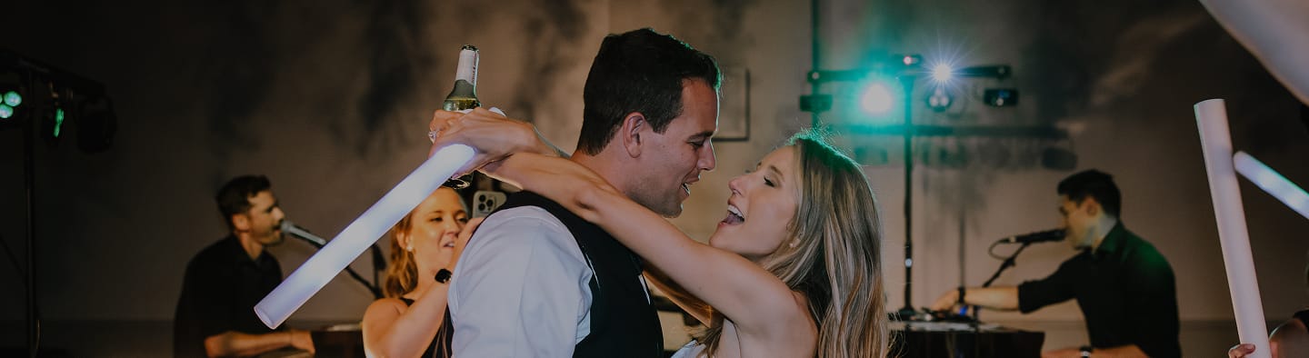 bride and groom singing and dancing on dance floor