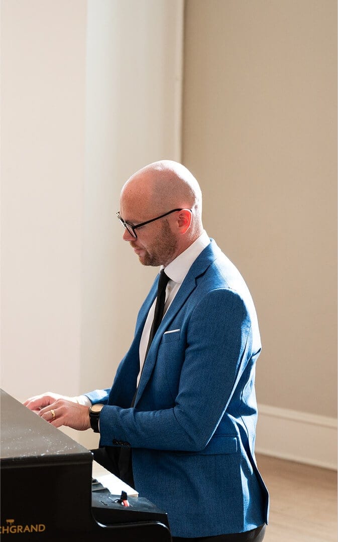 side view of gentleman playing piano