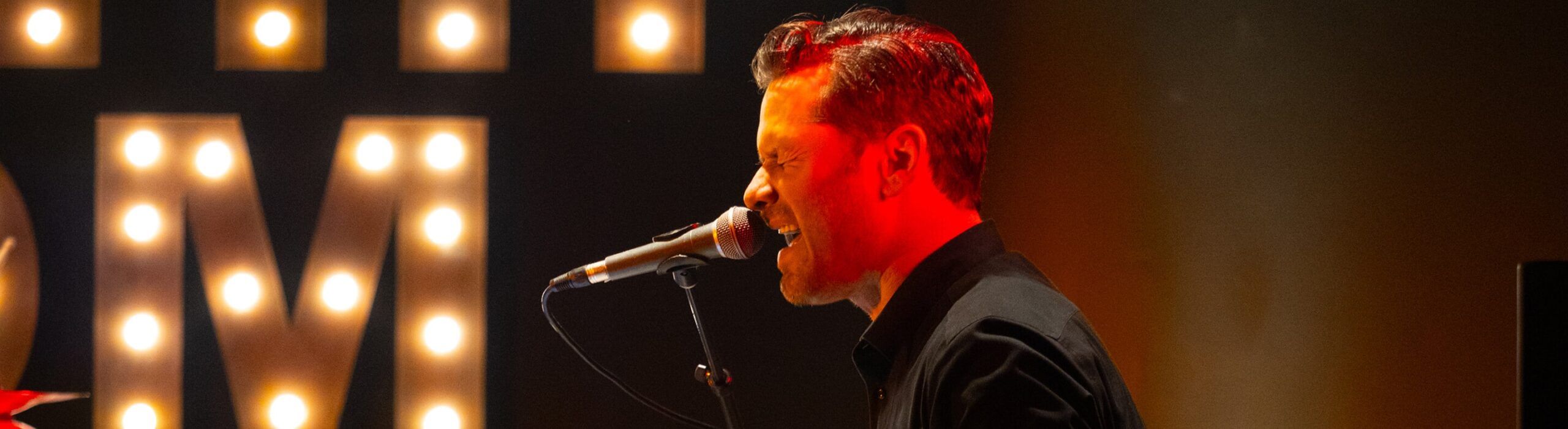 close-up of gentleman singing into microphone