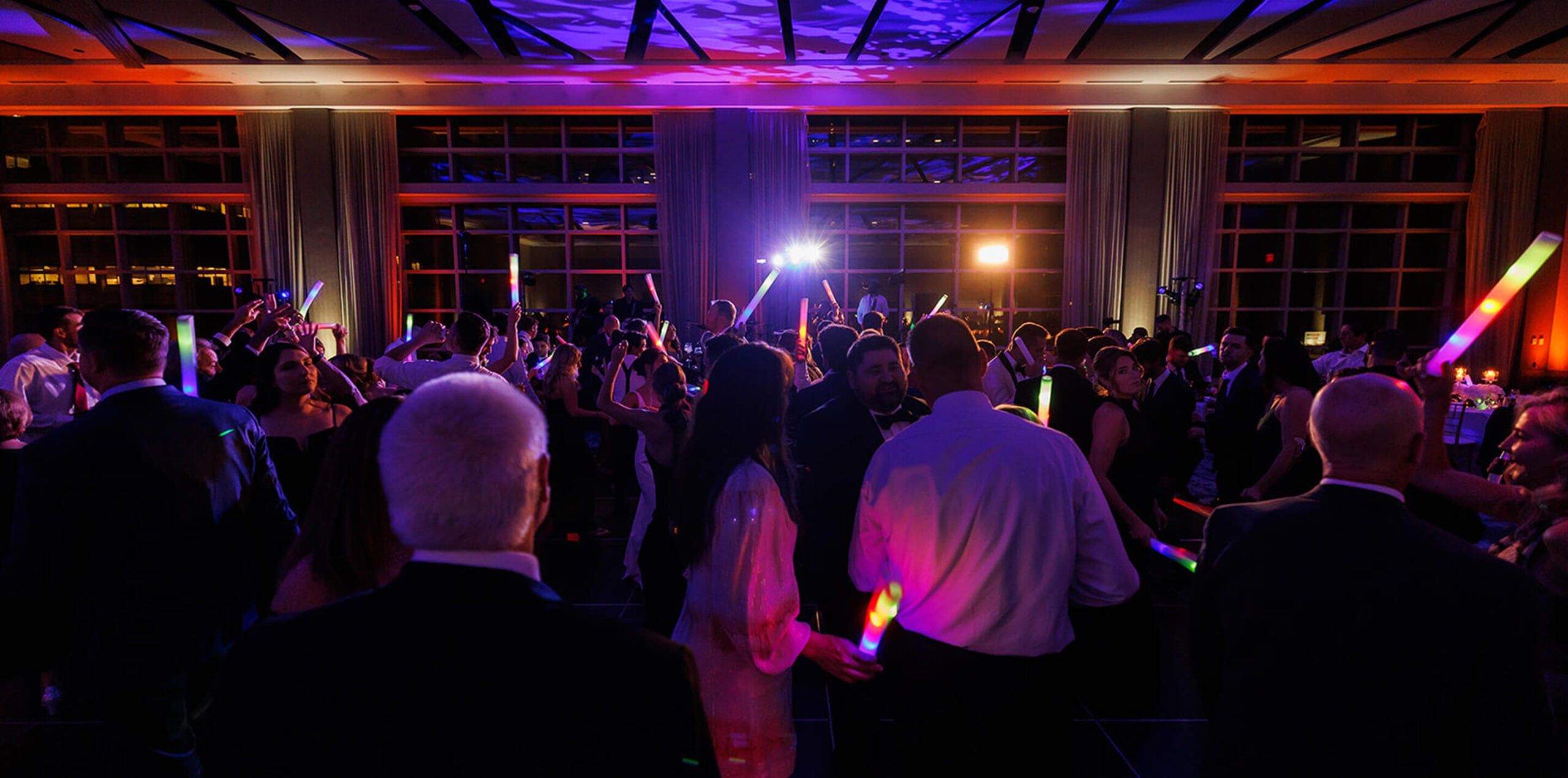 group of people celebrating with glow sticks