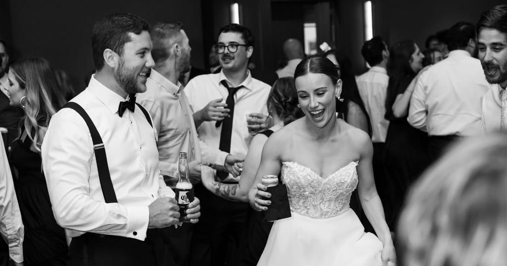 Leah and Norm celebrating their wedding black and white portrait