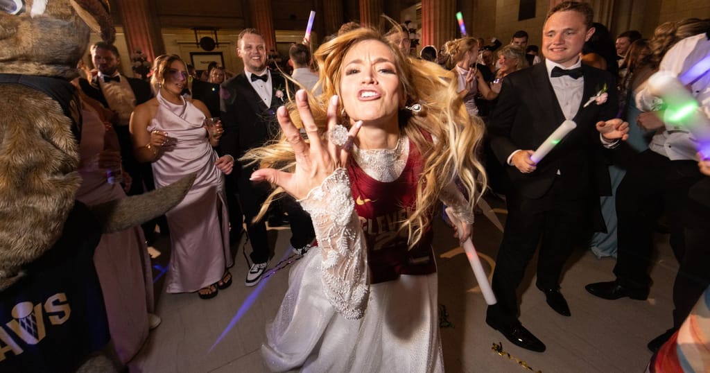 bride wearing cavs jersey celebrating at wedding