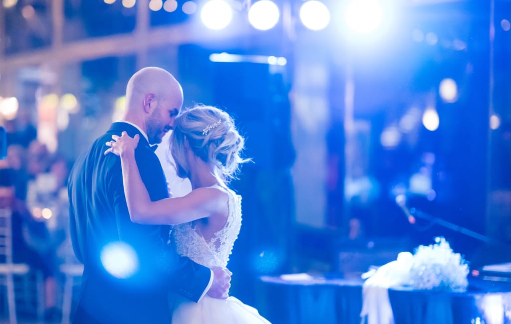 bride and groom dancing in spotlight