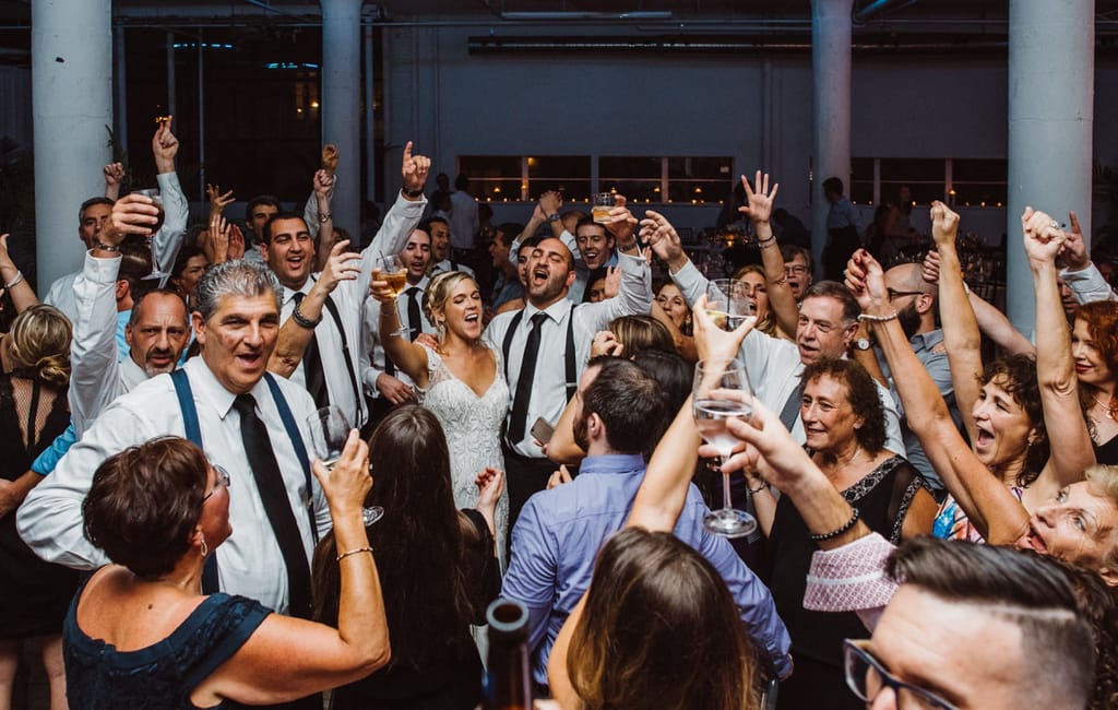 bridal party and family dancing at wedding
