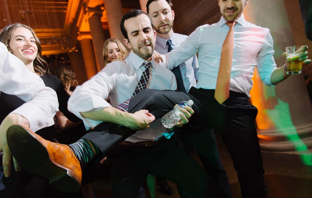 guests using gentleman leg for leg guitar at wedding
