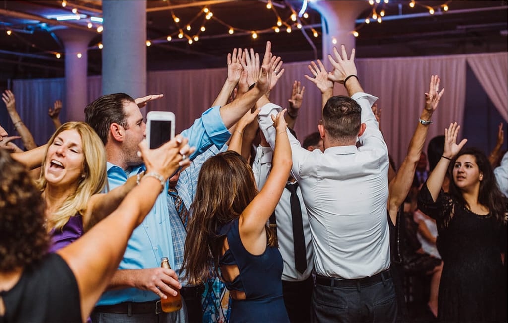 group of people dancing on dance floor at wedding