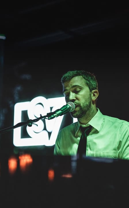close-up of gentleman singing into microphone at private party